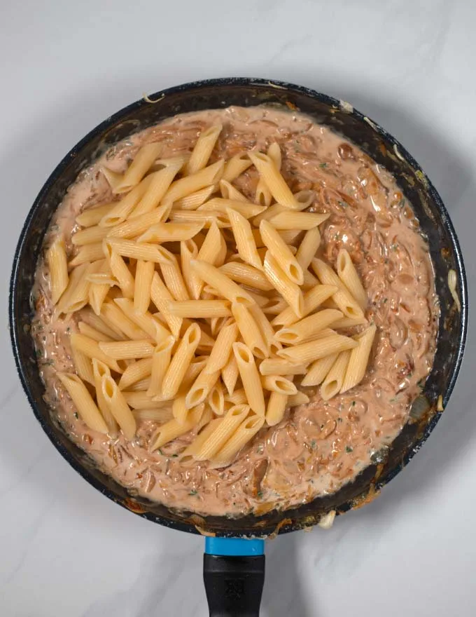 Precooked penne pasta is added to the French Onion sauce.