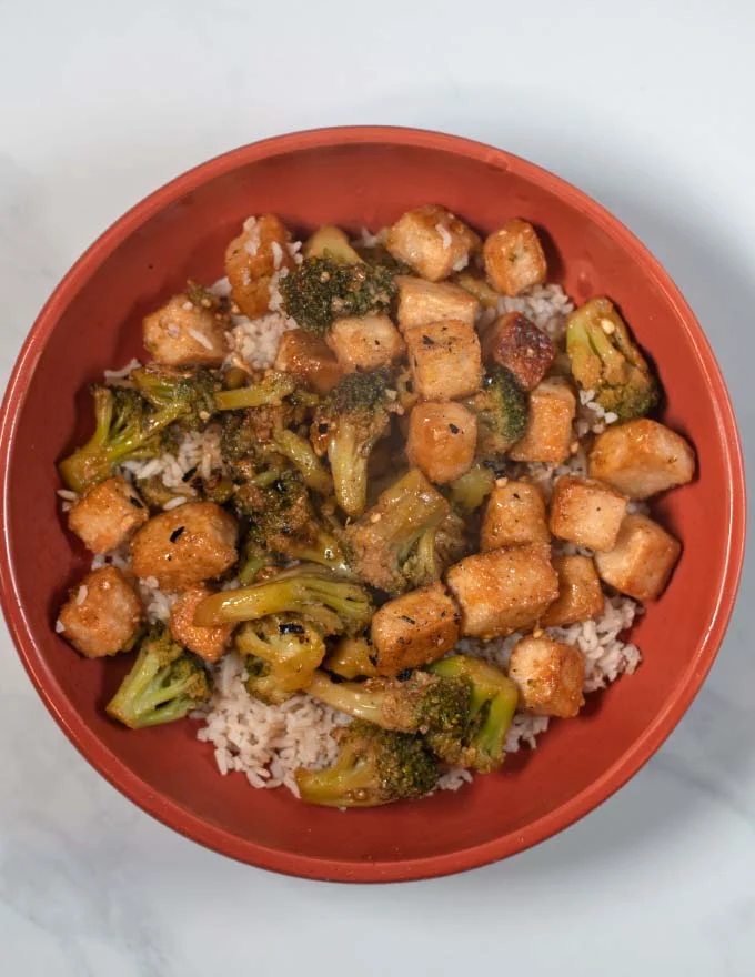 Tofu and Broccoli in Garlic Soy Sauce are served over rice.