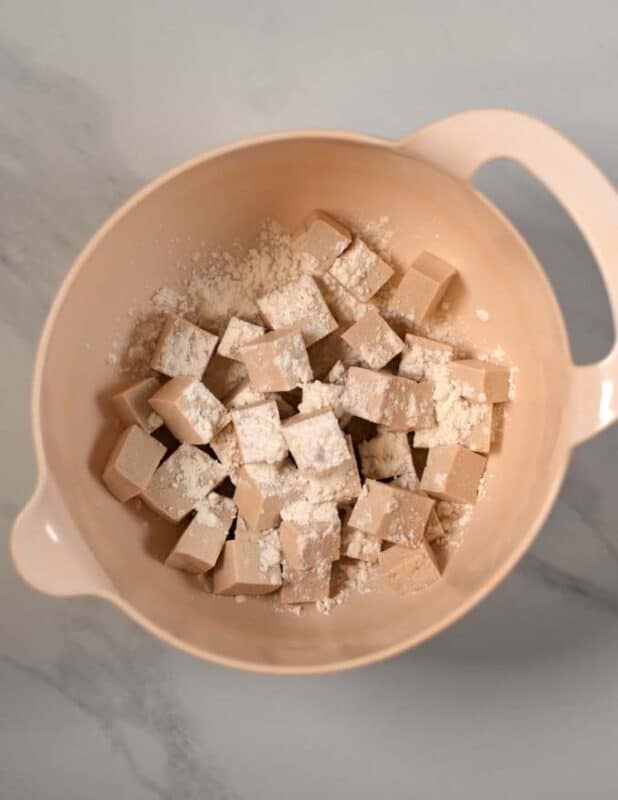 Tofu cubes are coated in corn starch.
