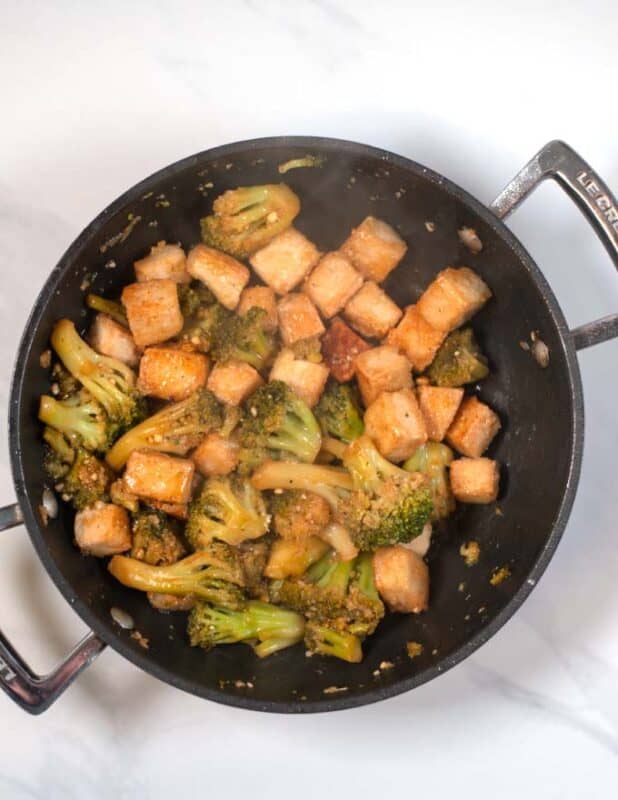 Tofu cubes are given back to the pan.
