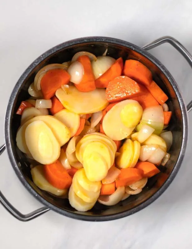 Potatoes are added to the soup pot.