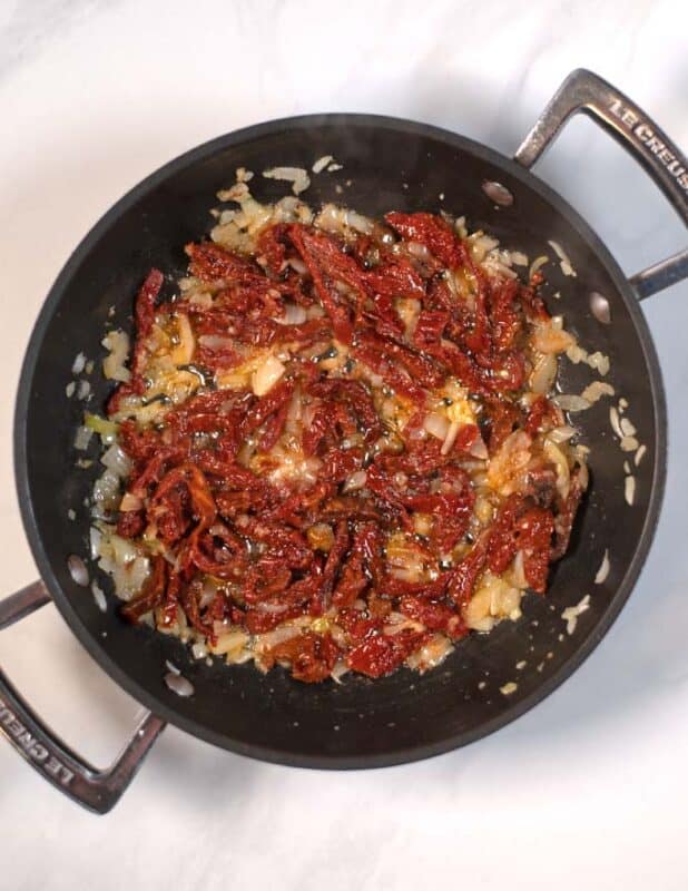 Sun-dried tomatoes are added to the pan.