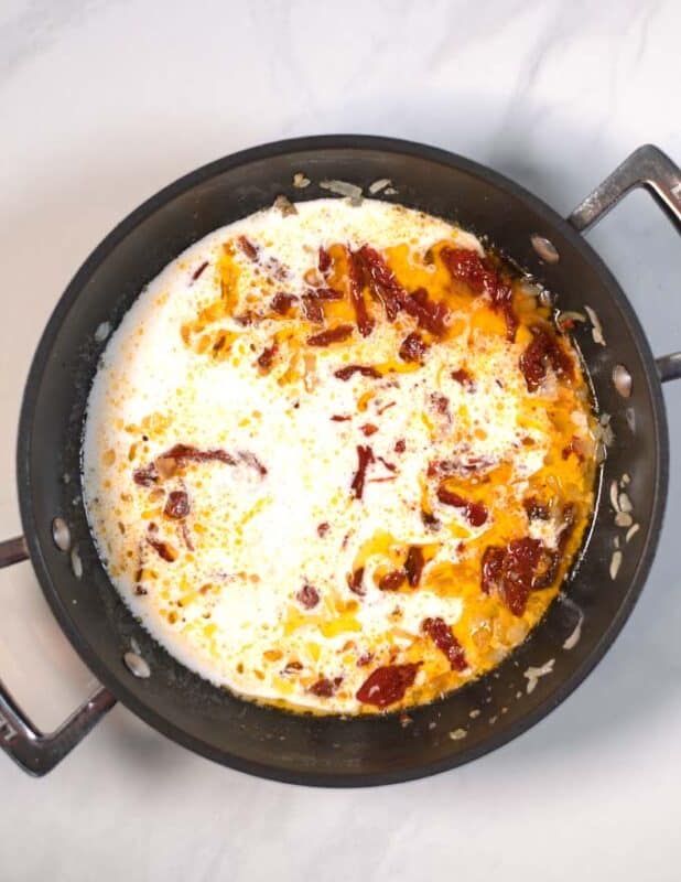 Liquid ingredients are mixed with the tomatoes and onions.