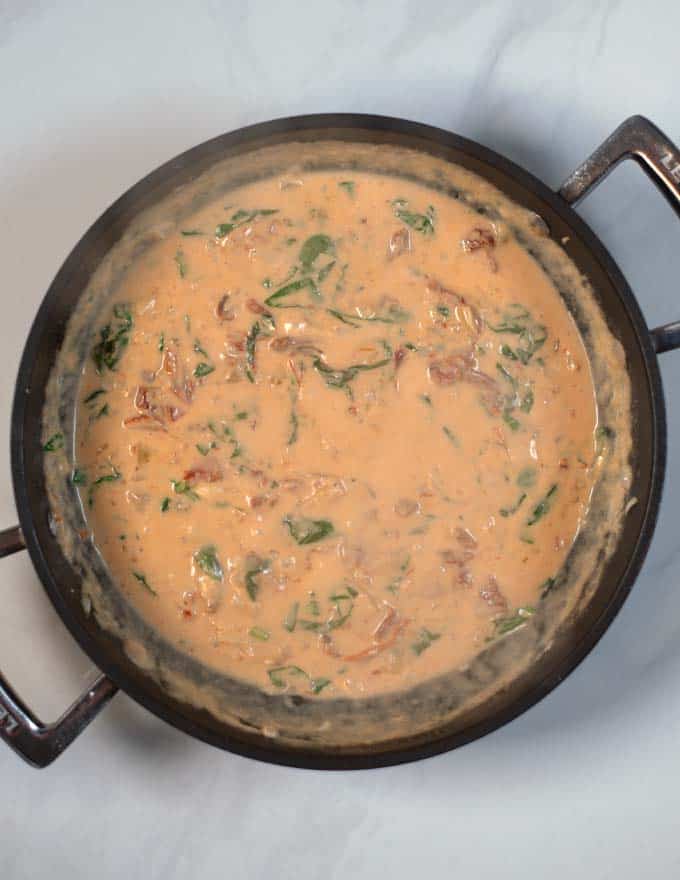 Fresh spinach is wilted in the sauce.