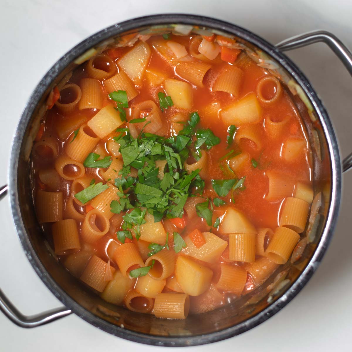 Seasonings and fresh herbs are mixed with the liquids.