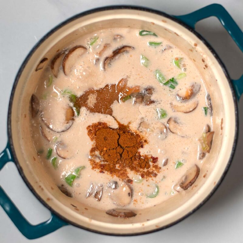 Liquid ingredients and spices are given to the mushrooms.