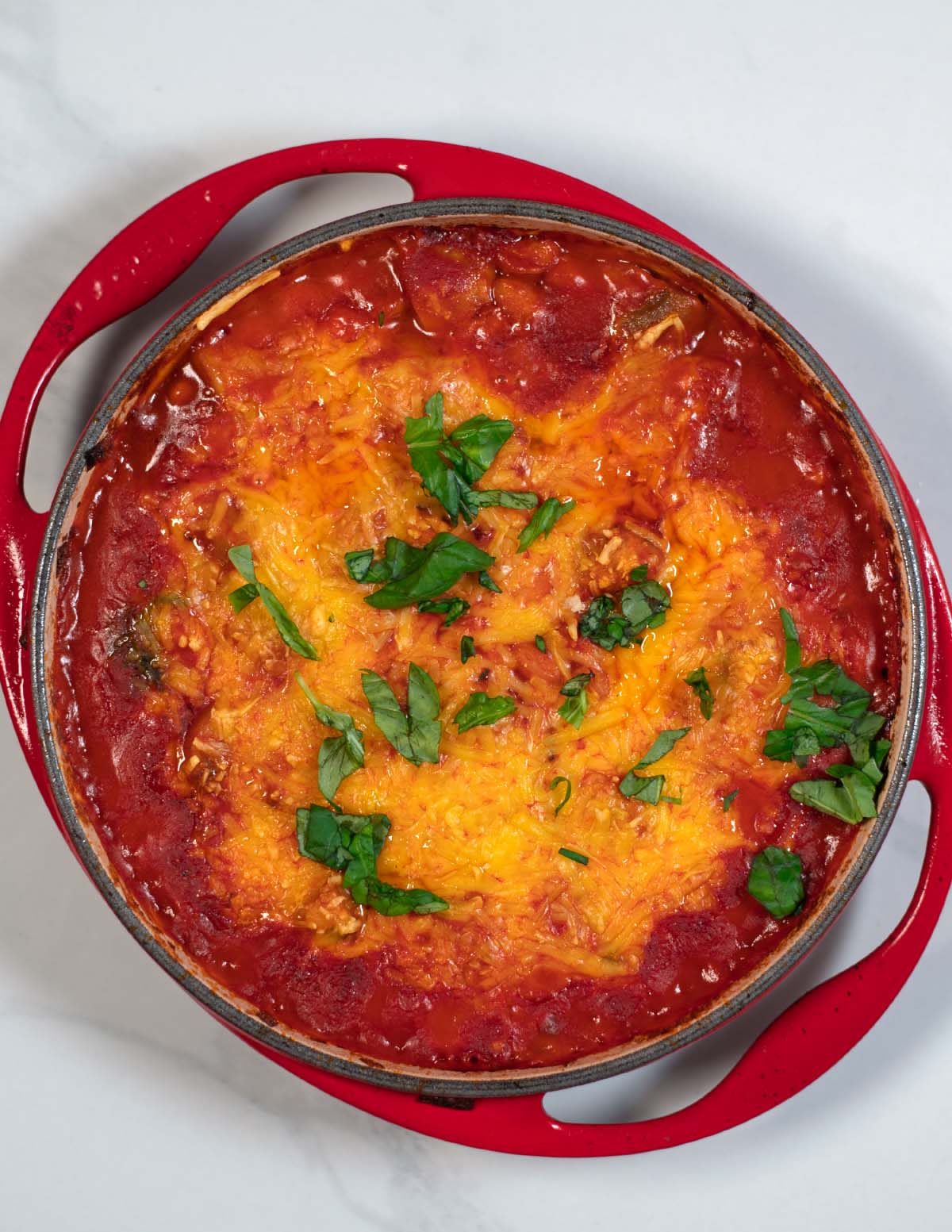 Fresh basil is used for garnish of Pizza Beans.