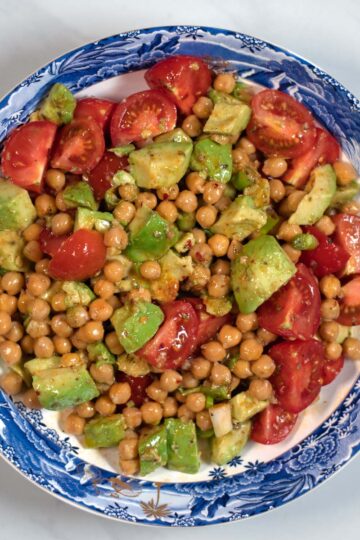 Avocado and Chickpea Salad served in a blue low bowl.