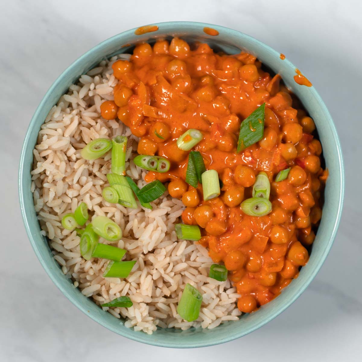 Serving of Butter Chickpeas with rice in a bowl.
