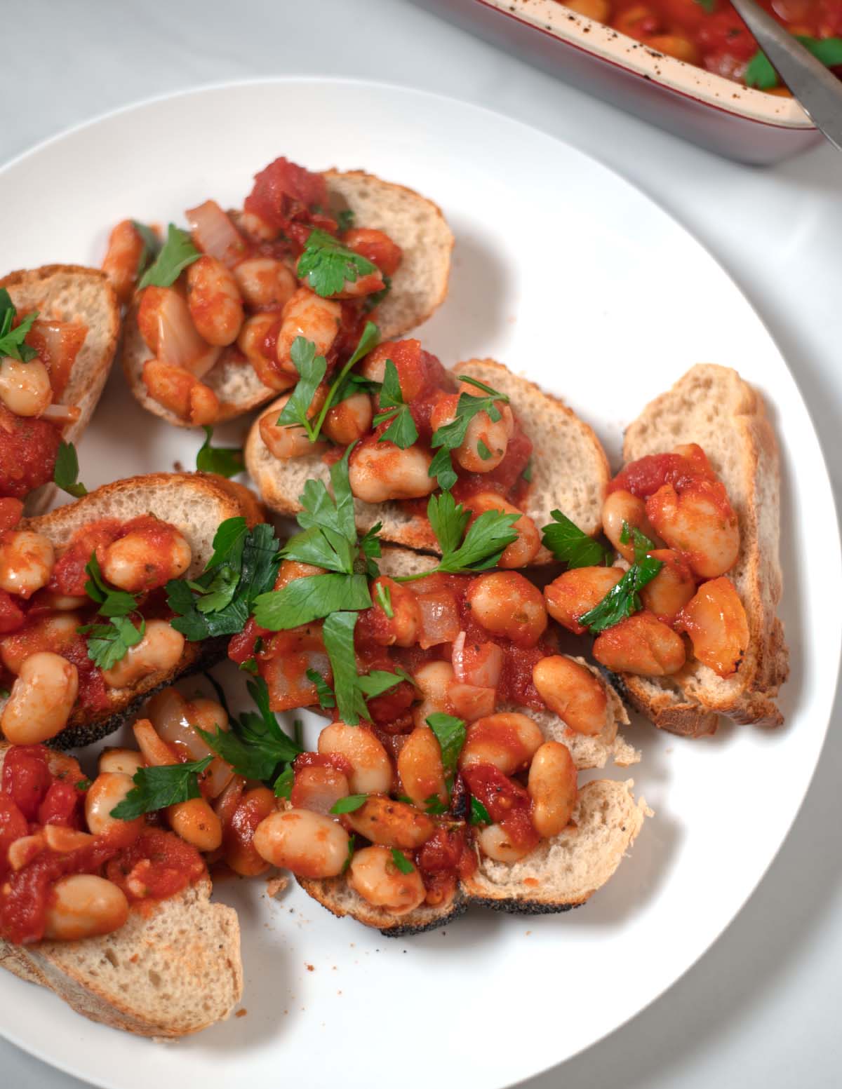 Closeup on bread with Gigantes Plaki.