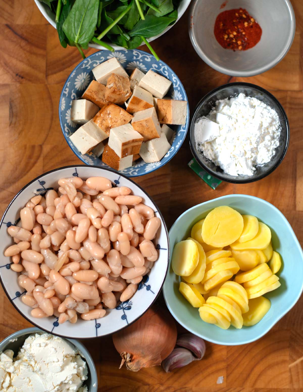 Ingredients needed to make Million Dollar Soup are collected on a wooden board.