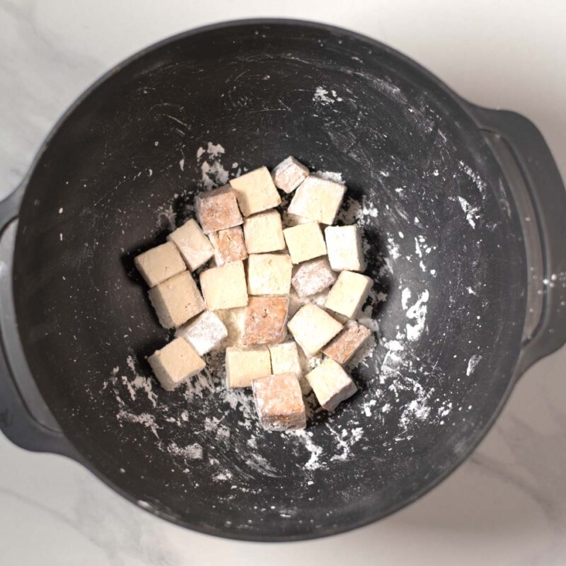 Tofu cubes are coated in corn starch.