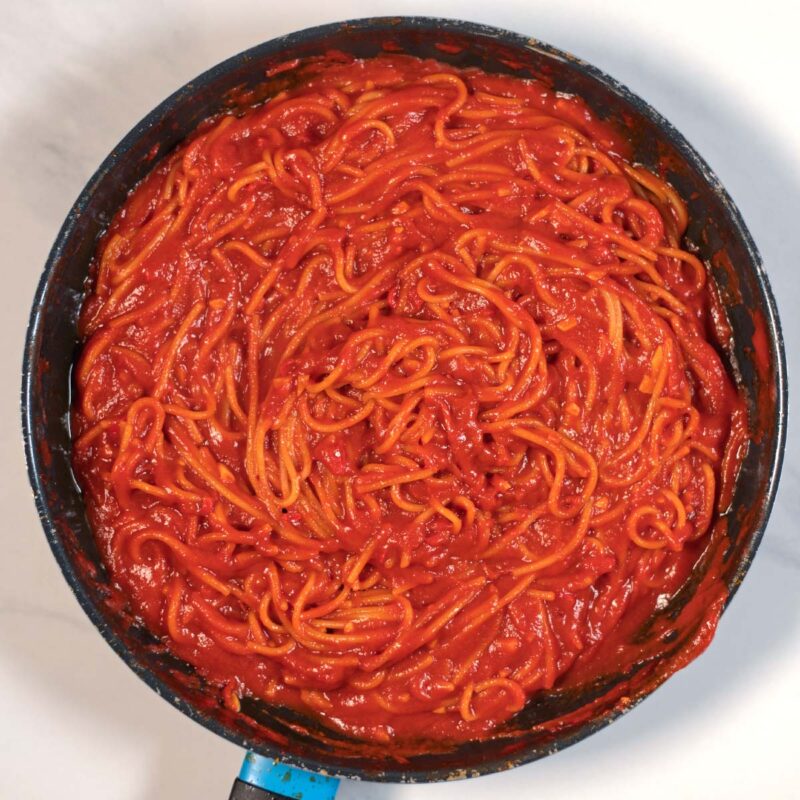 Cooked spaghetti in tomato sauce.