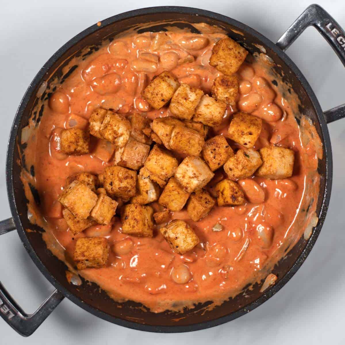 Cripsy tofy cubes are added back to the pan with the Creamy Tikka Masala Beans.
