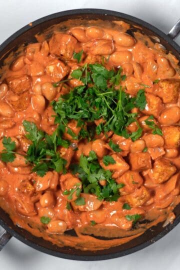 Fresh cilantro is used to garnish the Creamy Tikka Masala Beans.
