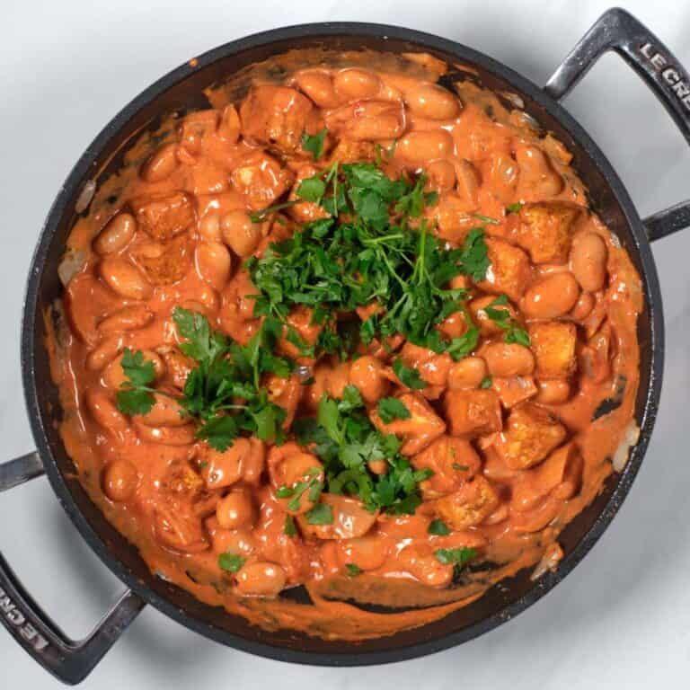 Fresh cilantro is used to garnish the Creamy Tikka Masala Beans.
