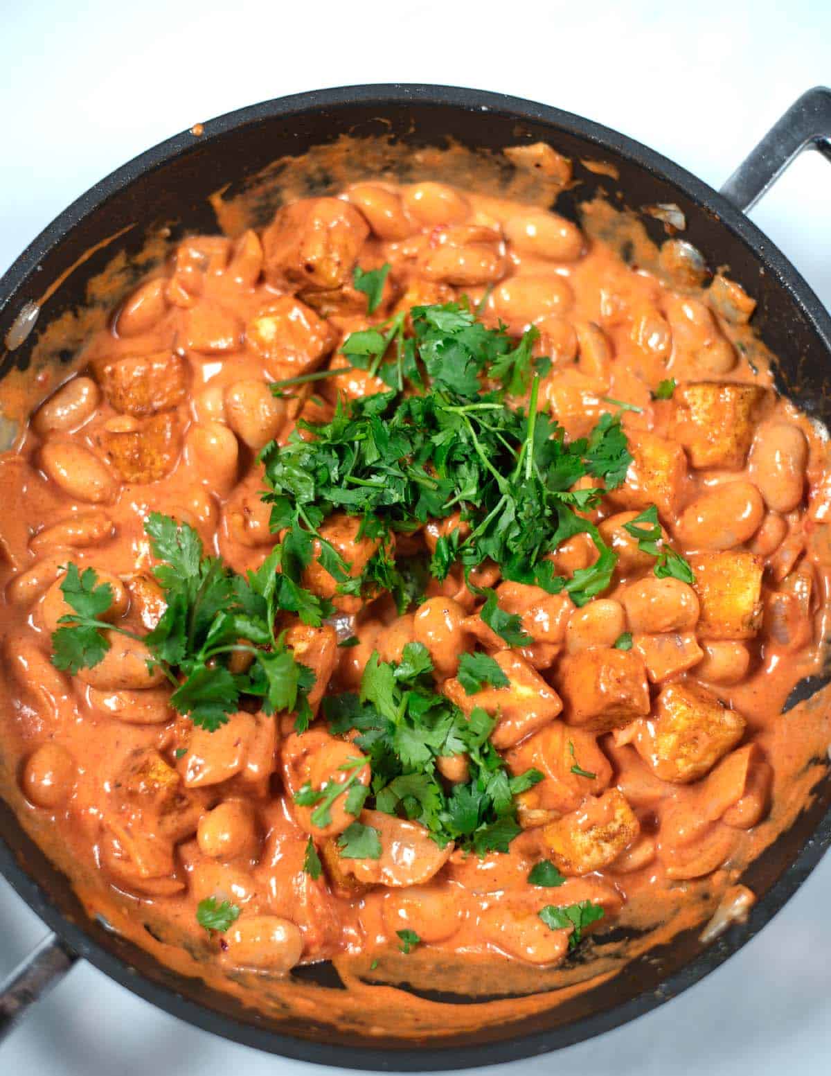 Closeup on Creamy Tikka Masala Beans in a large pan.