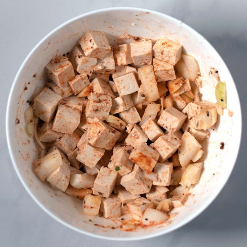 Tofu cubes and onions are tossed in cocunut milk with spices.