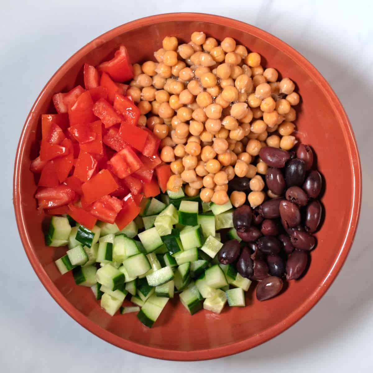 All salad ingredients in a large serving bowl.
