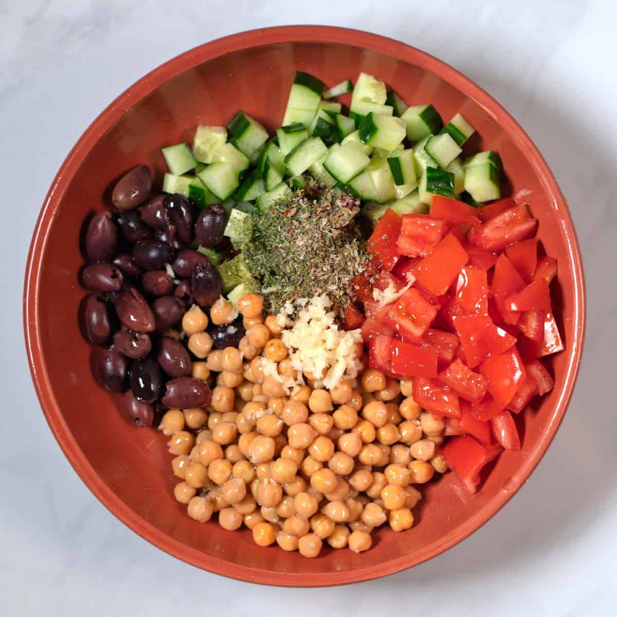 Seasonings and dressing ingredients are given over the vegetables.