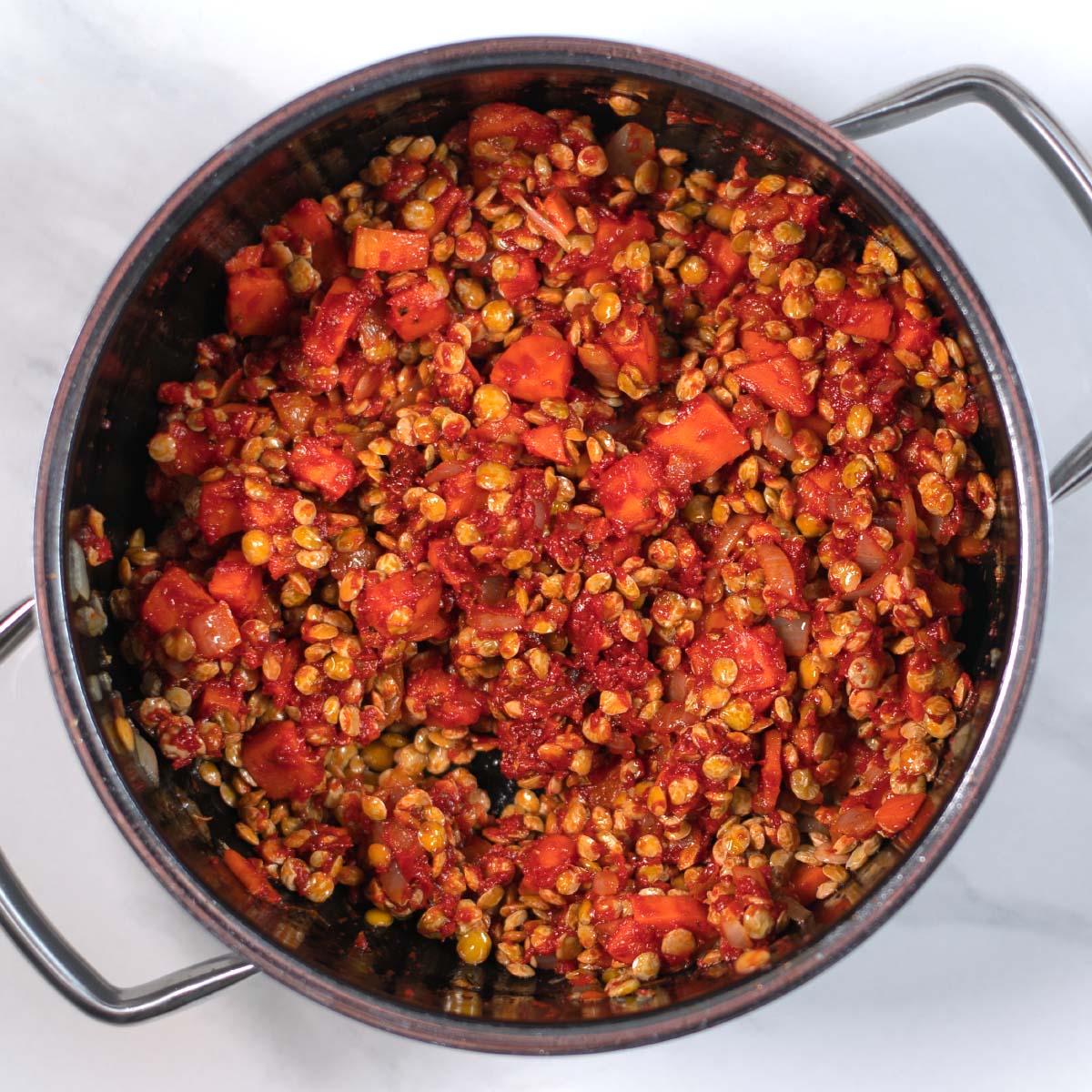 Showing a step in the preparation of Greek Lentil Soup before liquid is added.