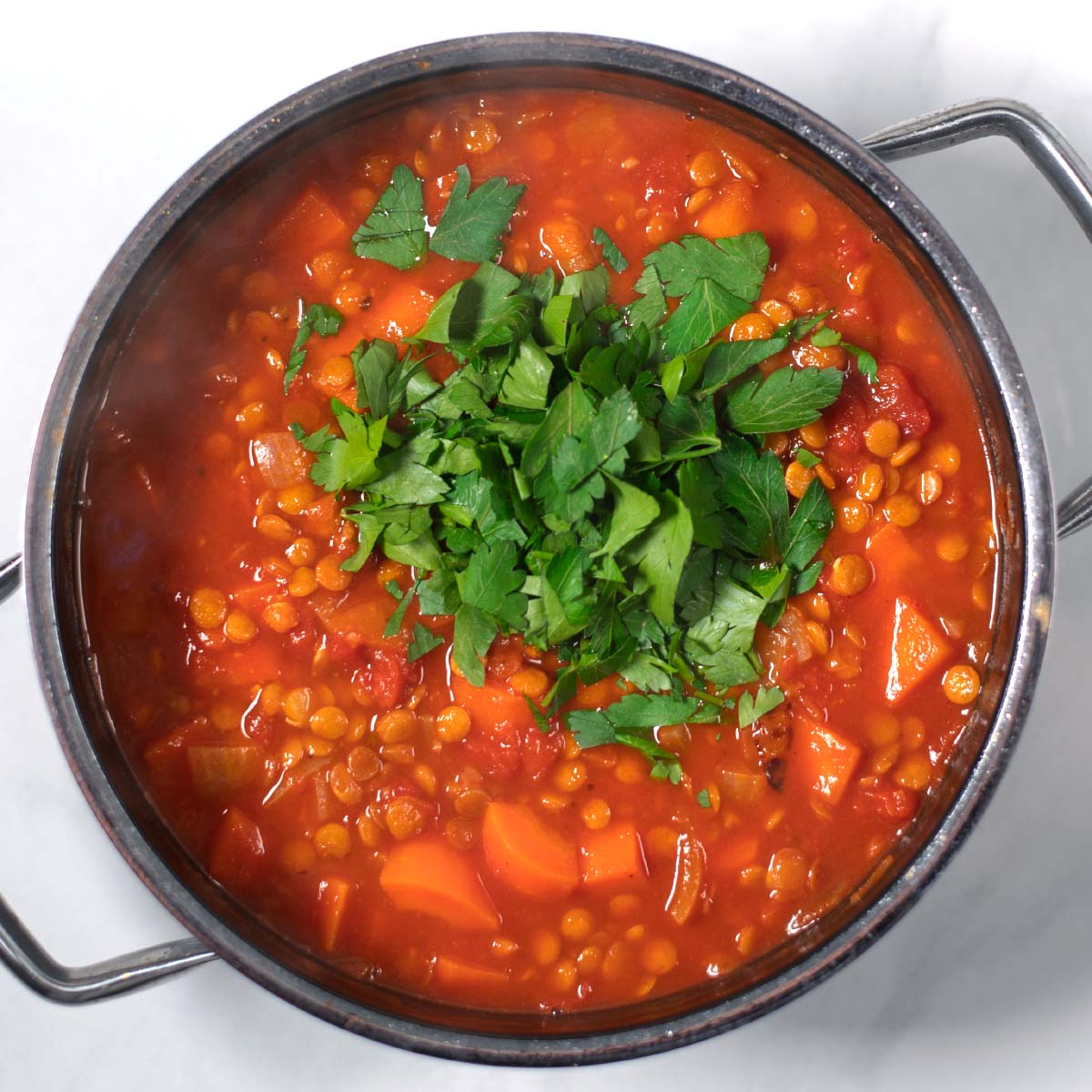 Fresh parsley is given into the Italian Lentil Soup.