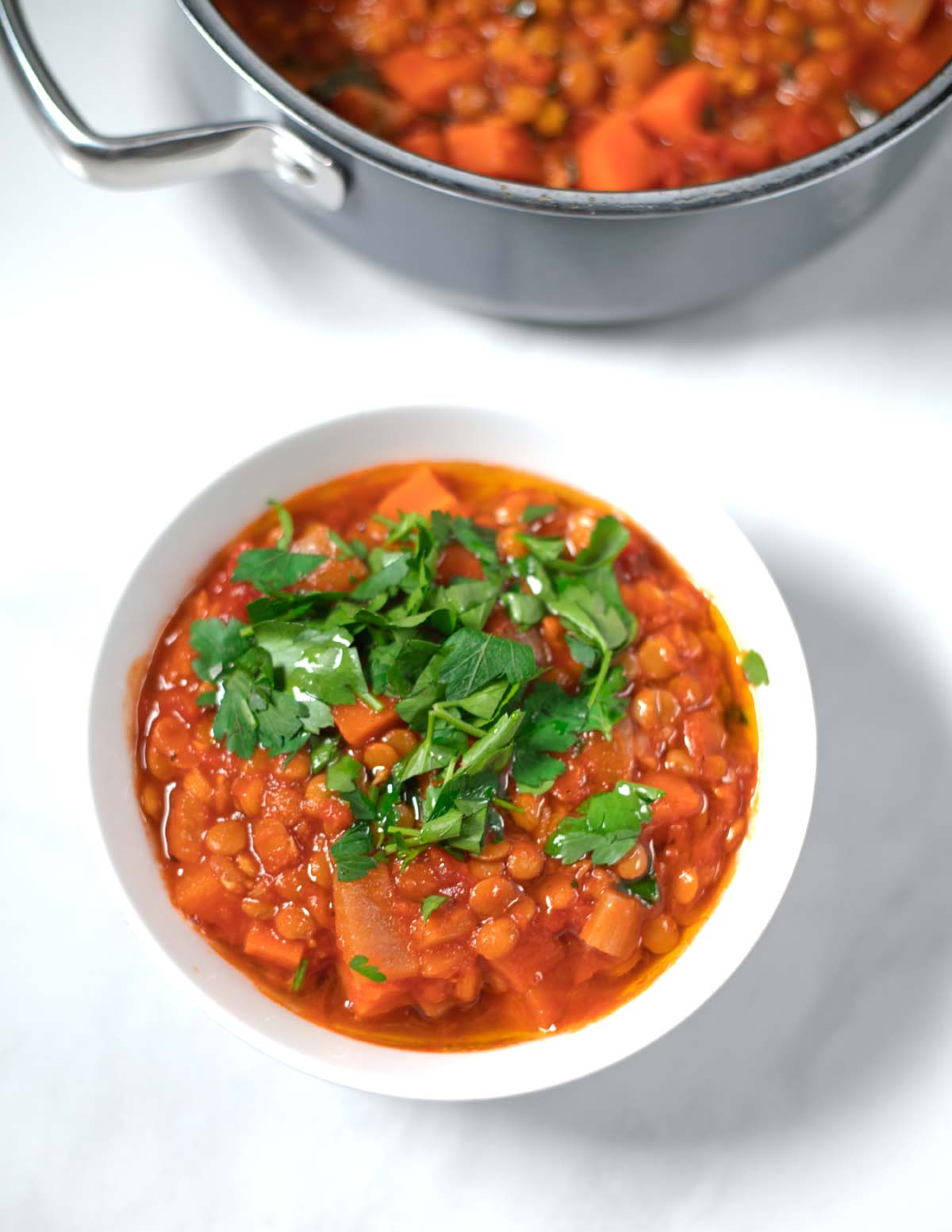 Italian Lentil Soup is served in a bowl with fresh parsley.