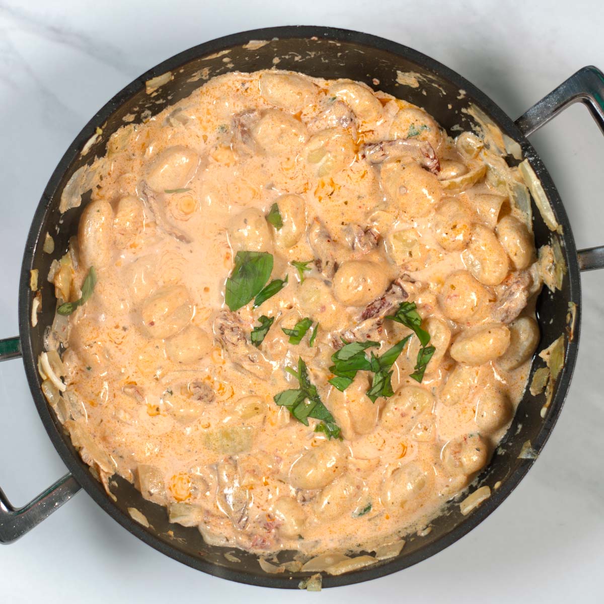 Top view on a pan with the ready Marry Me Gnocchi.