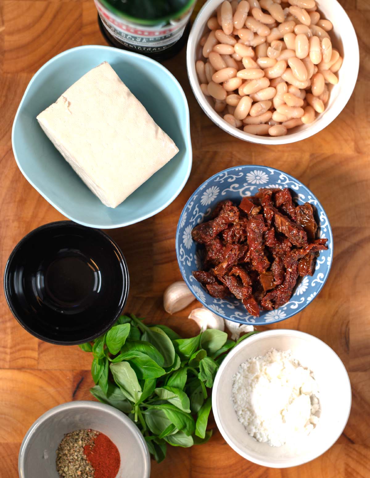 Ingredients needed to make Marry Me Salad are collected before preparation on a wooden board.