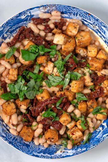 Marry Me Salad serving on a large plate, garnished with fresh basil.