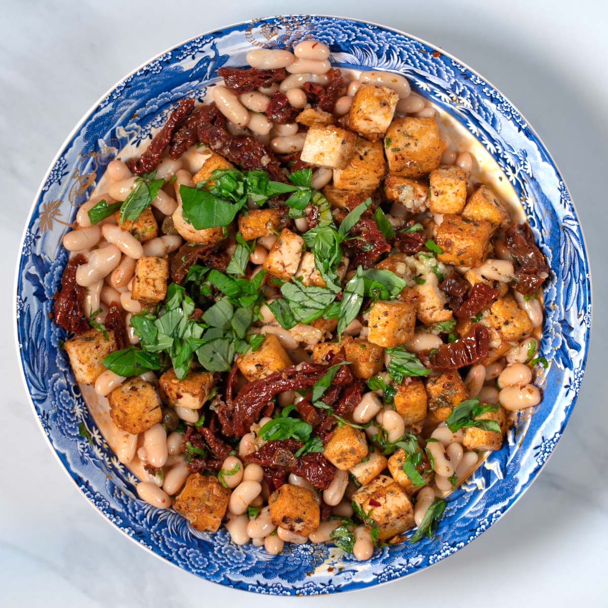 Marry Me Salad serving on a large plate, garnished with fresh basil.