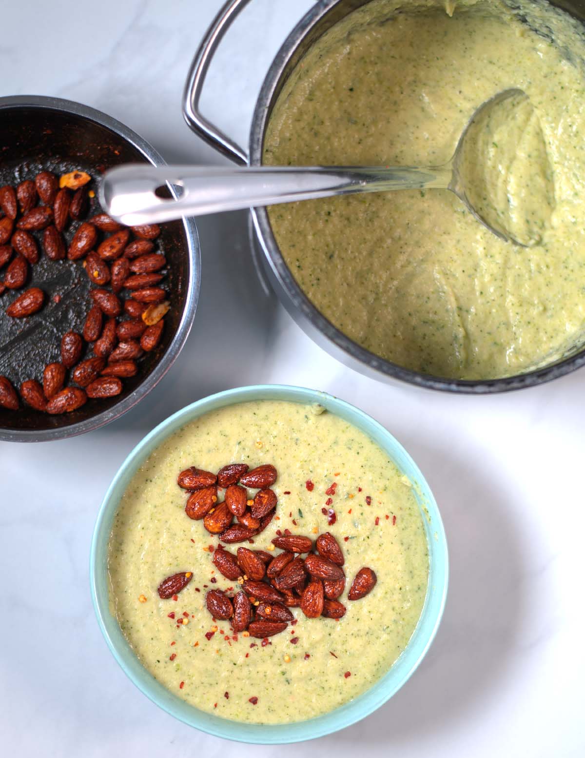 A large serving of Zucchini Soup with spicy almond topping.