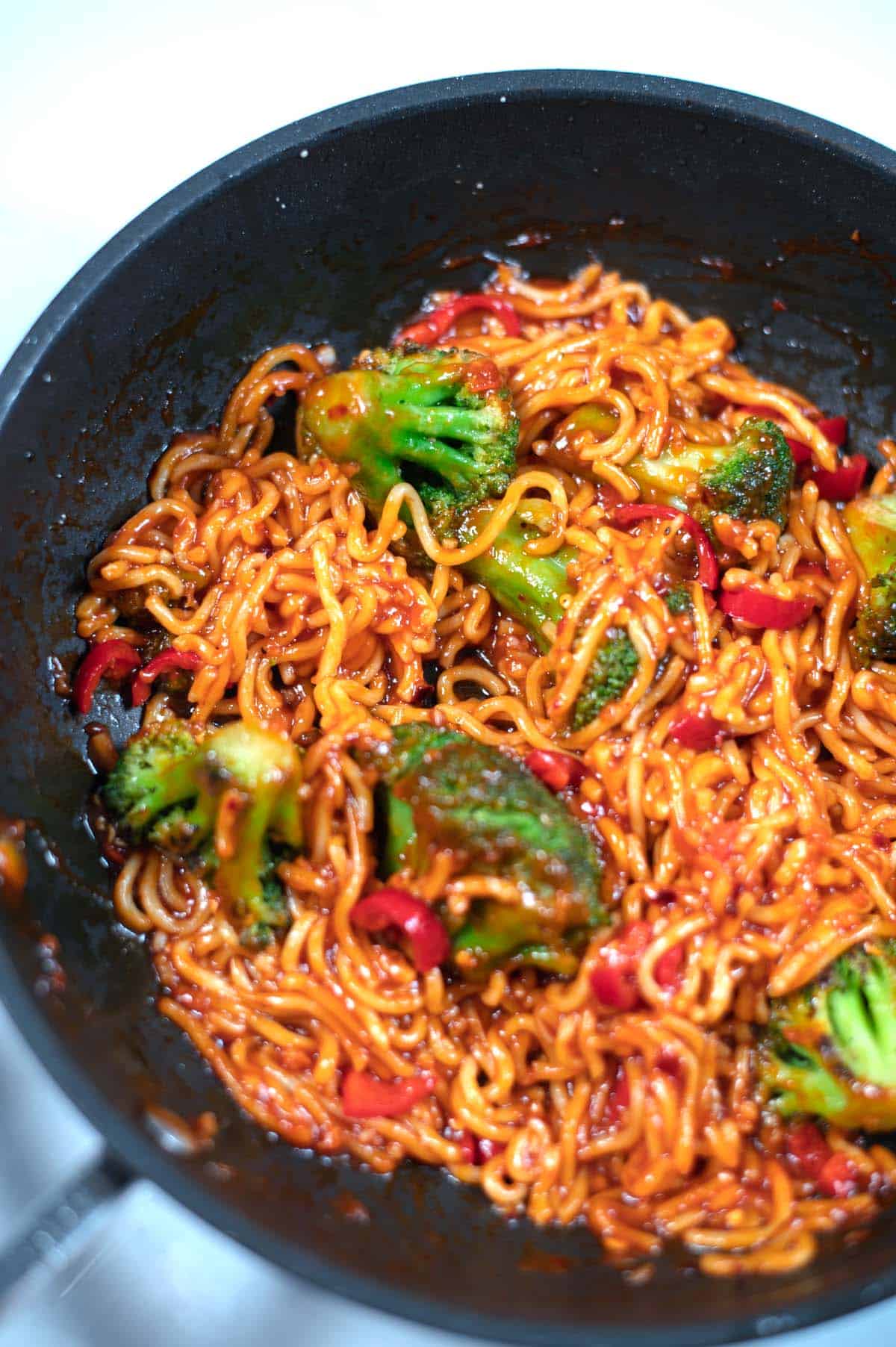 Crunchy broccoli in red and spicy Chili Noodles.