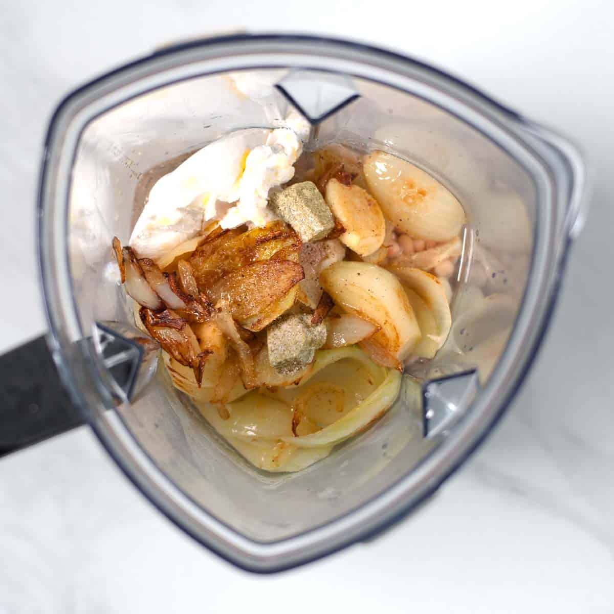 Sauce ingredients for the Million Dollar Potatoes are ginven into the bowl of a blender.