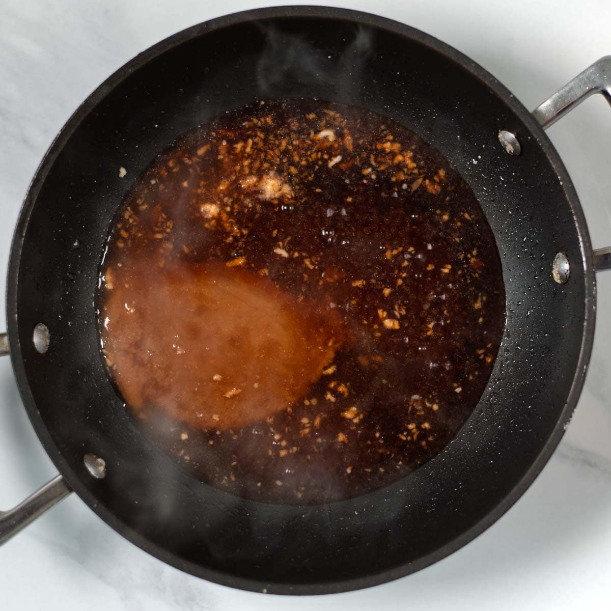 Liquid ingredients for the sticky miso sauce are given to a small pan.