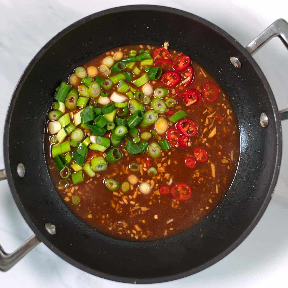 Red Chili and green onion are mixed with the sticky sauce.