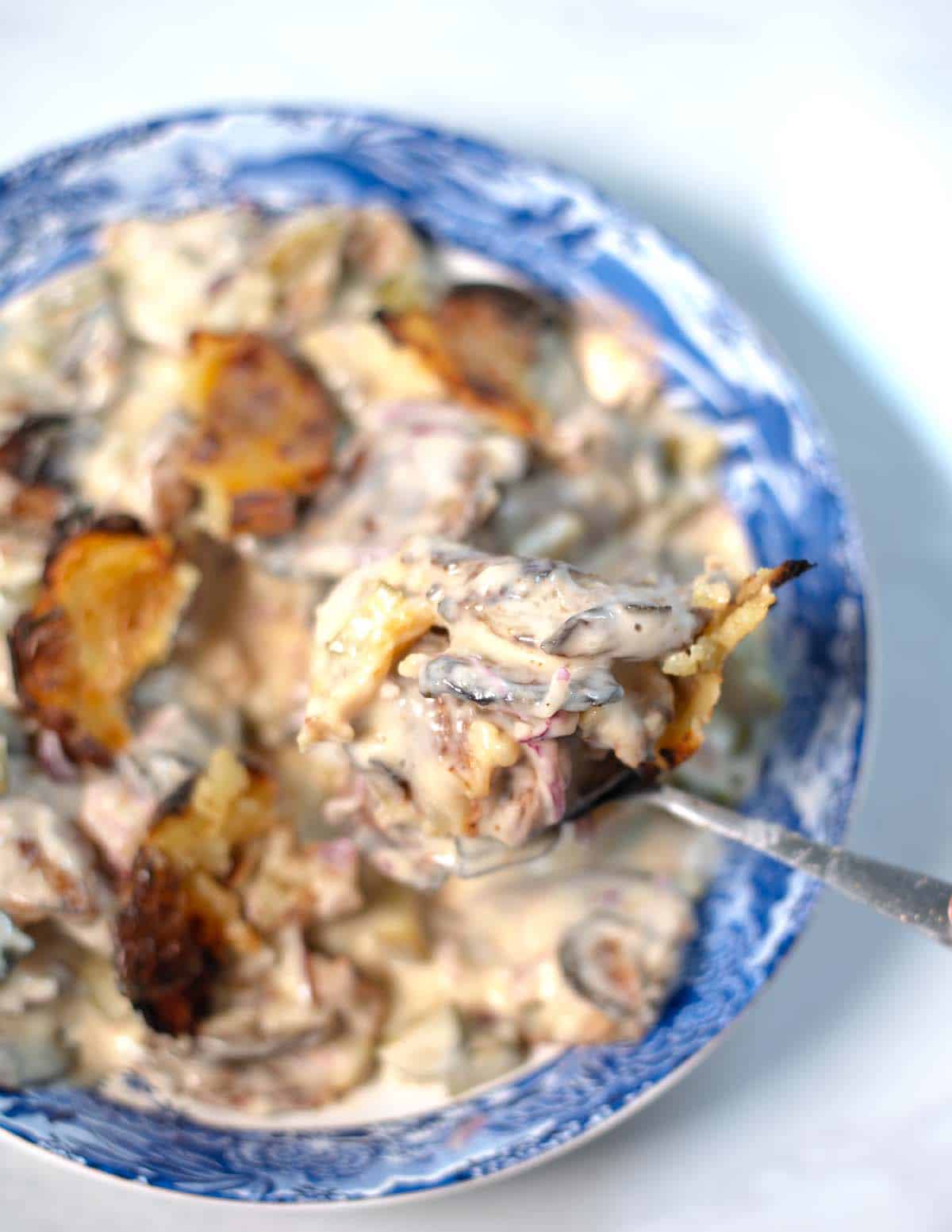 A large spoonful of smashed potato salad.