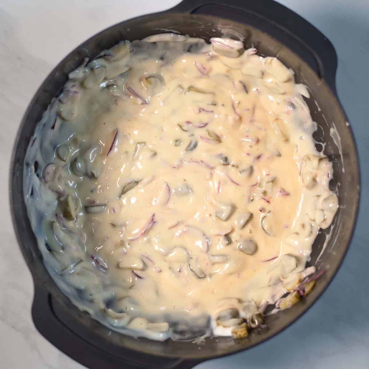 Creamy dressing ready in a mixing bowl.