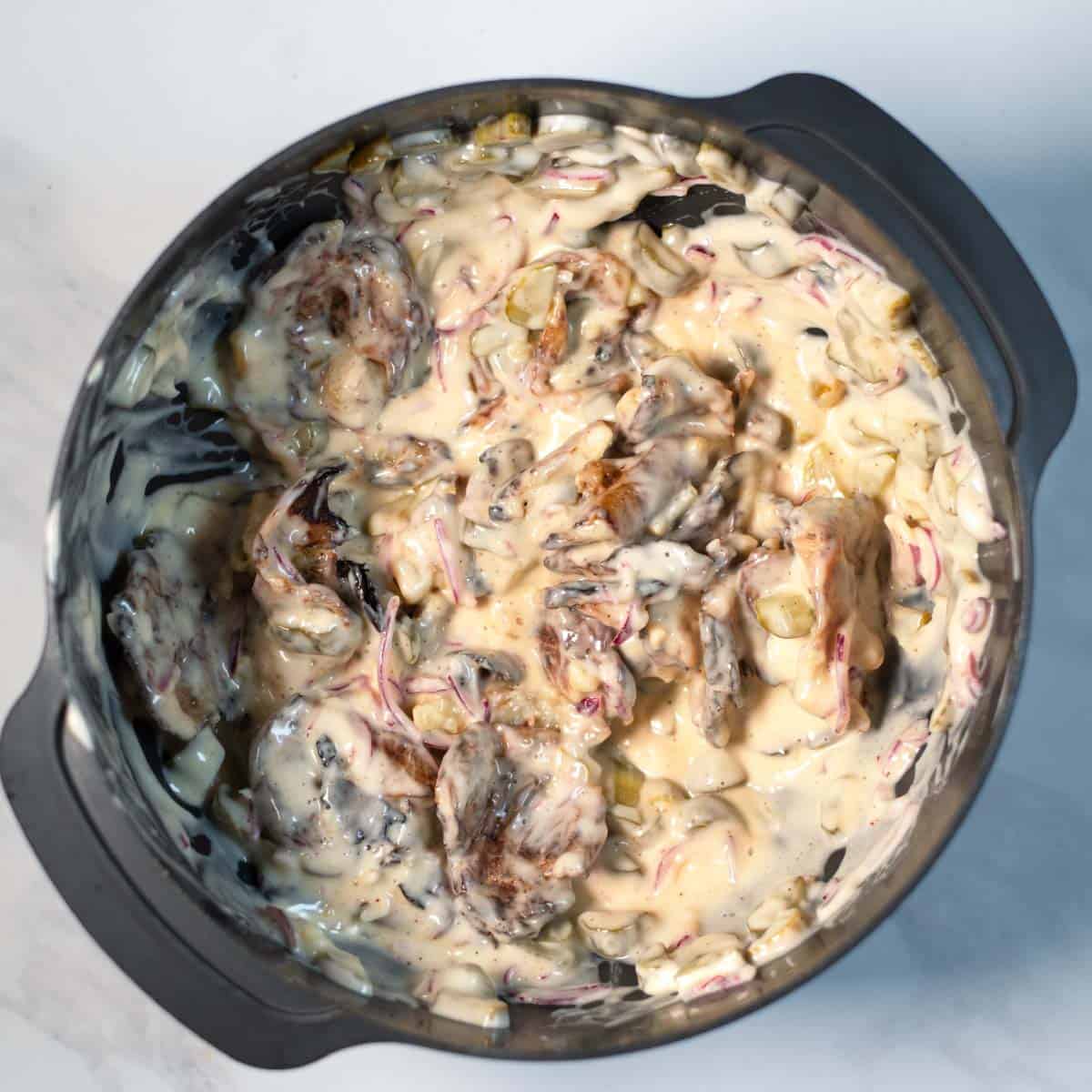 The ready Smashed Potato Salad in a mixing bowl.