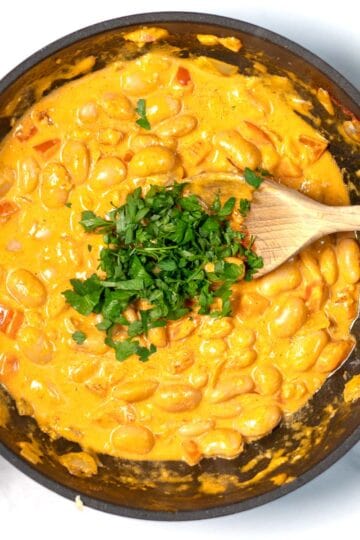 Parsley is used to garnish Creamy Harissa Butter Beans.