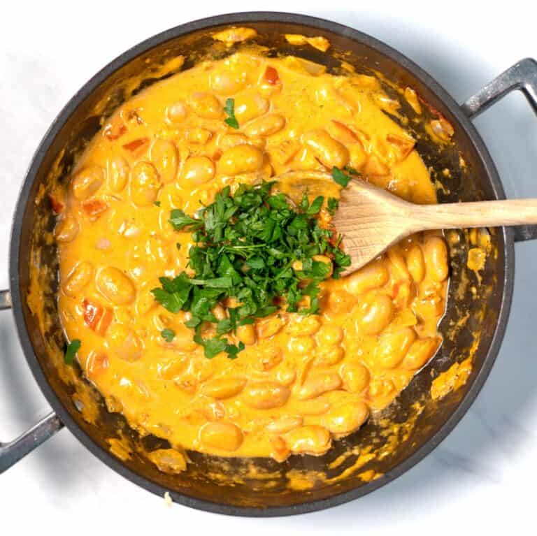 Parsley is used to garnish Creamy Harissa Butter Beans.