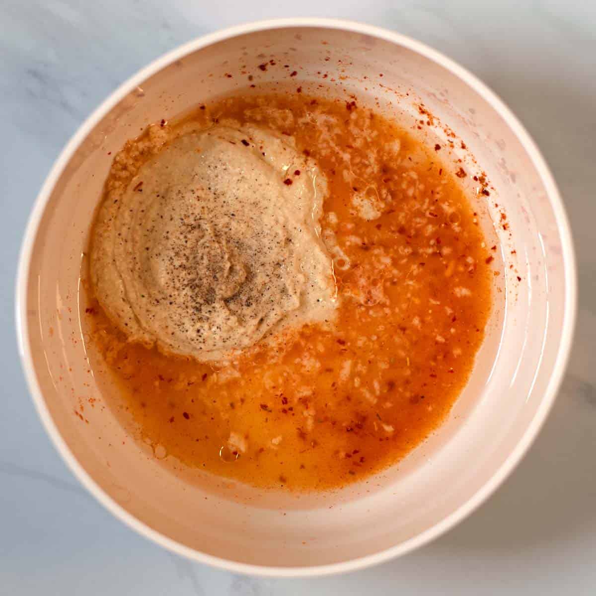 The Hummus Dressing is mixed in a large bowl.