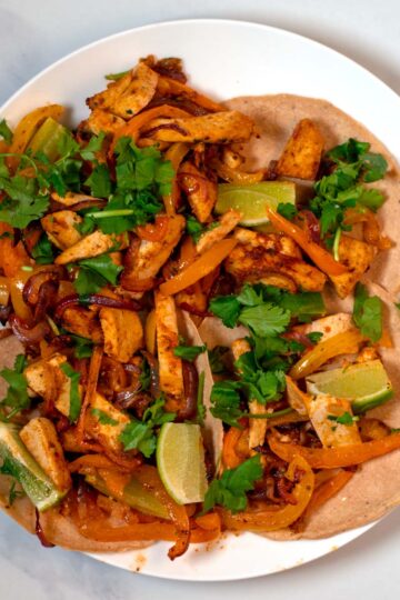 Serving of Sheet Pan Fajitas on tortillas.