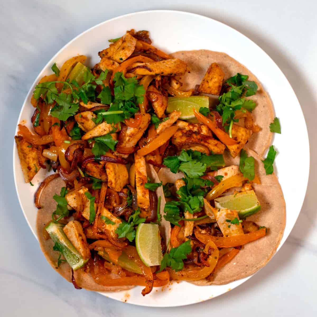 Serving of Sheet Pan Fajitas on tortillas.