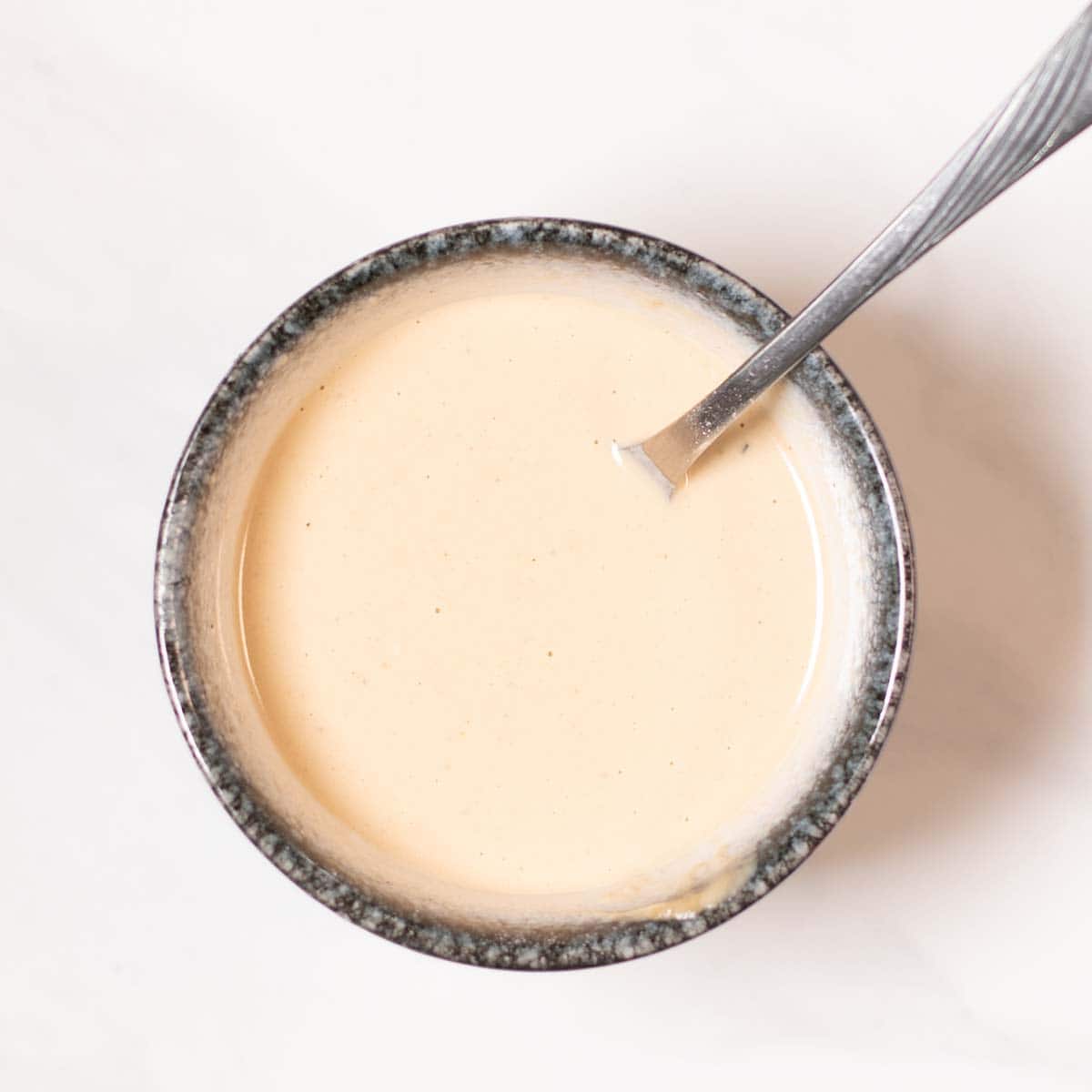 The creamy Tahini Miso Dressing in a small bowl.