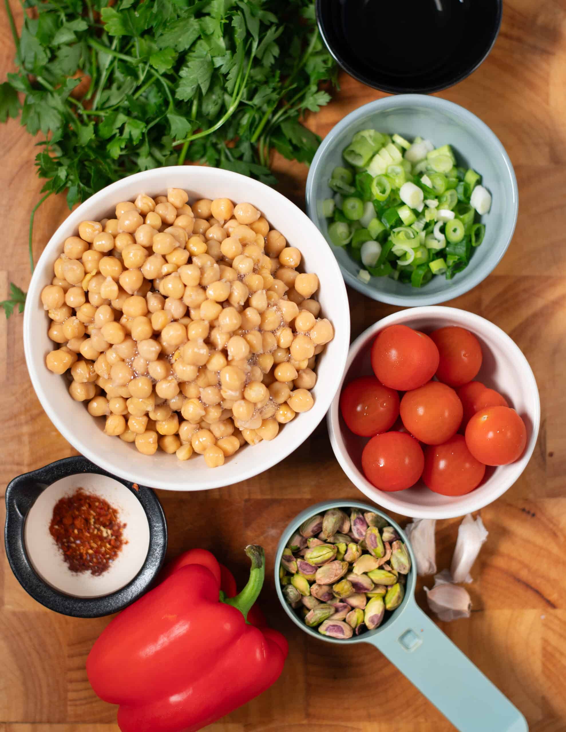 Ingredients needed to make Balela Salad collected on a board.