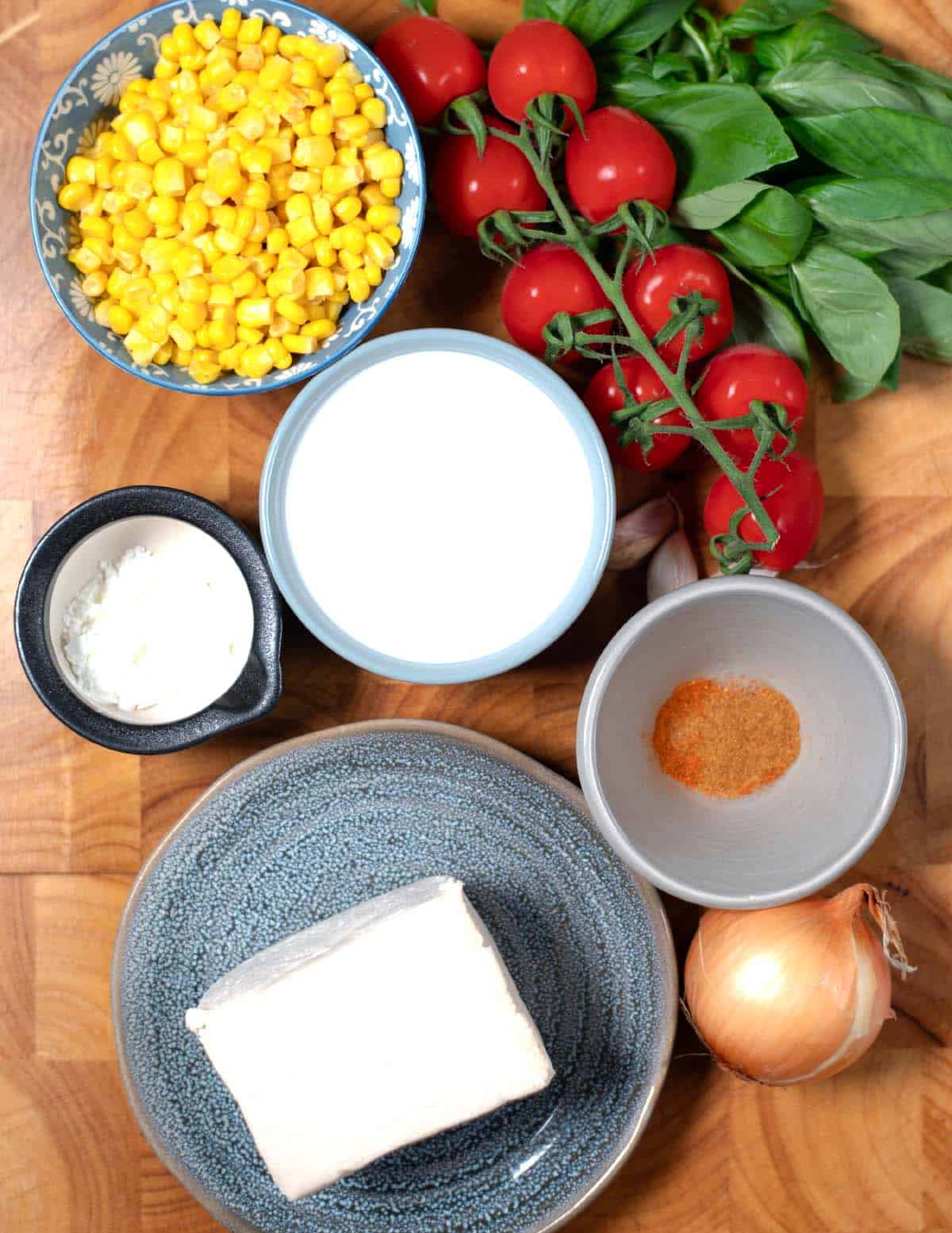 Ingredients needed to make Basil Tofu are collected on a board.