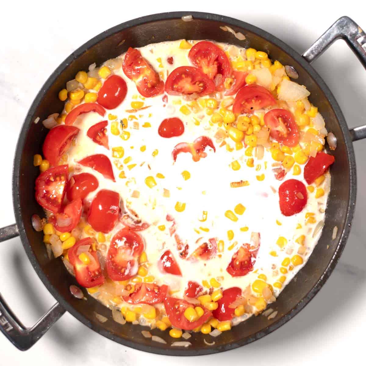 Coconut milk is added to the pan.