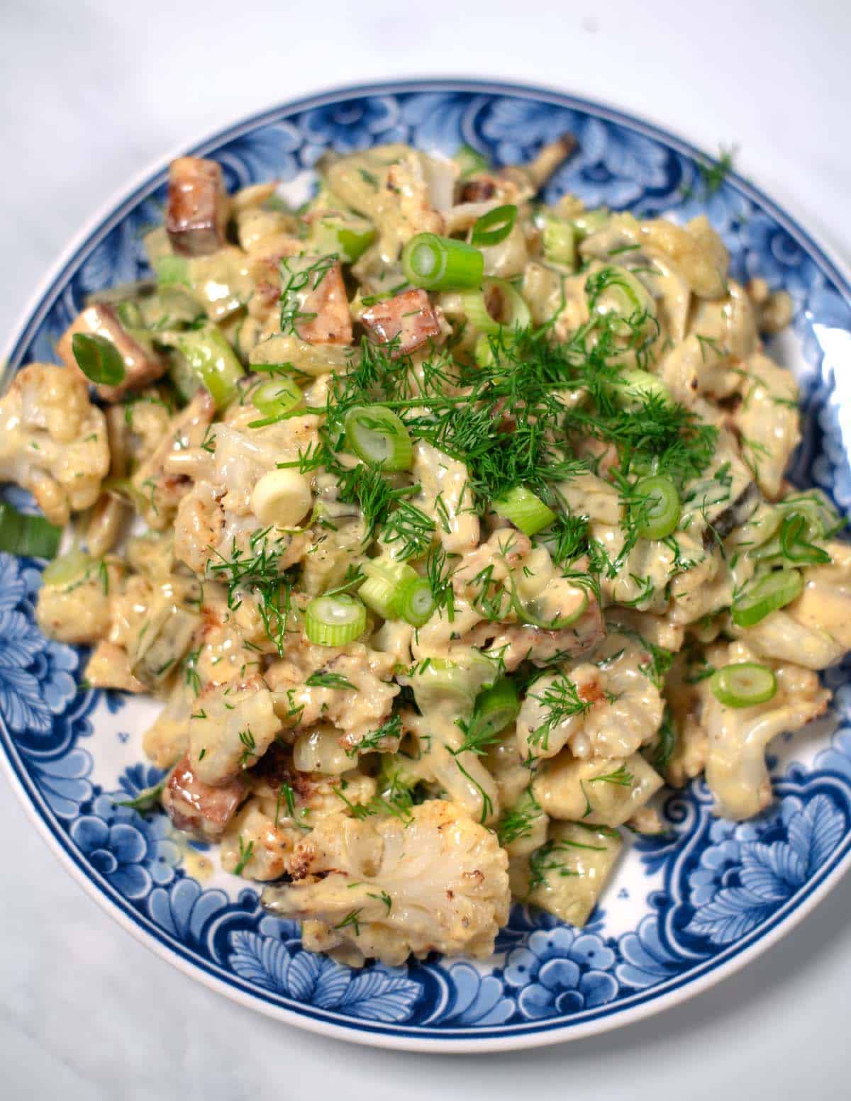 Closeup on a serving of Cauliflower Potato Salad.