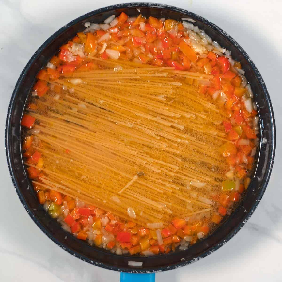 Pasta is covered in vegetable broth.